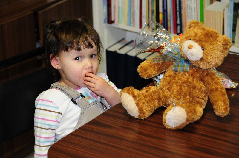 Little girl receiving a stuffed animal through the bear4russia program