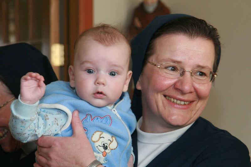 Nun holding baby